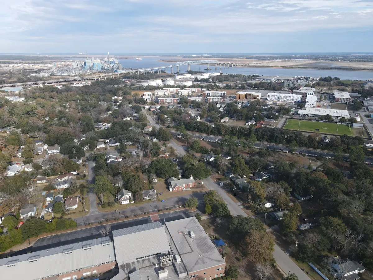 A sweeping view of the river, bridge, cityscape, and surrounding residential area. The image conveys a sense of adventure, community, and easy access to local attractions and outdoor activities.